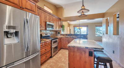A home in McDowell Mountain Ranch, Scottsdale Arizona with wooden cabinets and stainless steel appliances.
