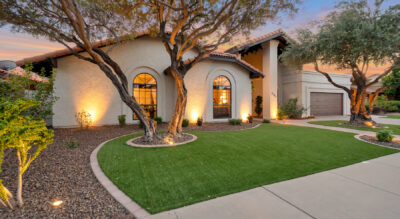 A Paradise Park Manor home with artificial grass and trees at dusk in the McCormick Ranch neighborhood.