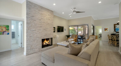 A home in Tierra Santa at McCormick Ranch with a living room featuring a fireplace and a flat screen tv.