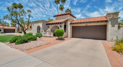 A home in Tierra Santa at McCormick Ranch with corner lot, palm trees and a garage.