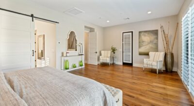 A bedroom in the elegant Silverleaf at DC Ranch community featuring wood floors and a comfortable bed.