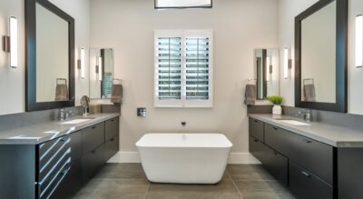 A modern bathroom with a large tub and sink located at 20497 N 100th Pl Scottsdale Silverleaf at DC Ranch.