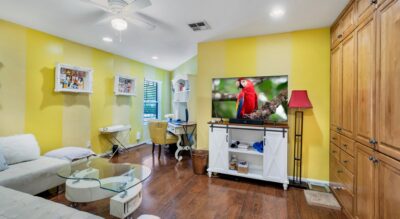 A den or 4th bedroom in McCormick Ranch with yellow walls and a TV.